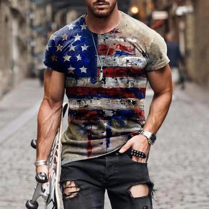 Man wearing American flag graphic tee with distressed design and holding a skateboard on cobblestone street