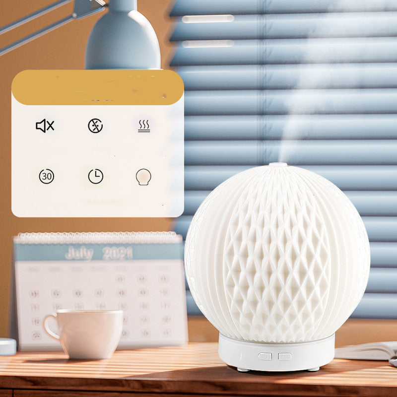 Sheila Merchandise automatic essential oil diffuser with white honeycomb design on wooden desk
