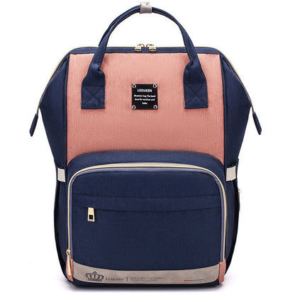 Sheila Merchandise parent-approved diaper backpack in navy and pink with multiple compartments and sturdy handles
