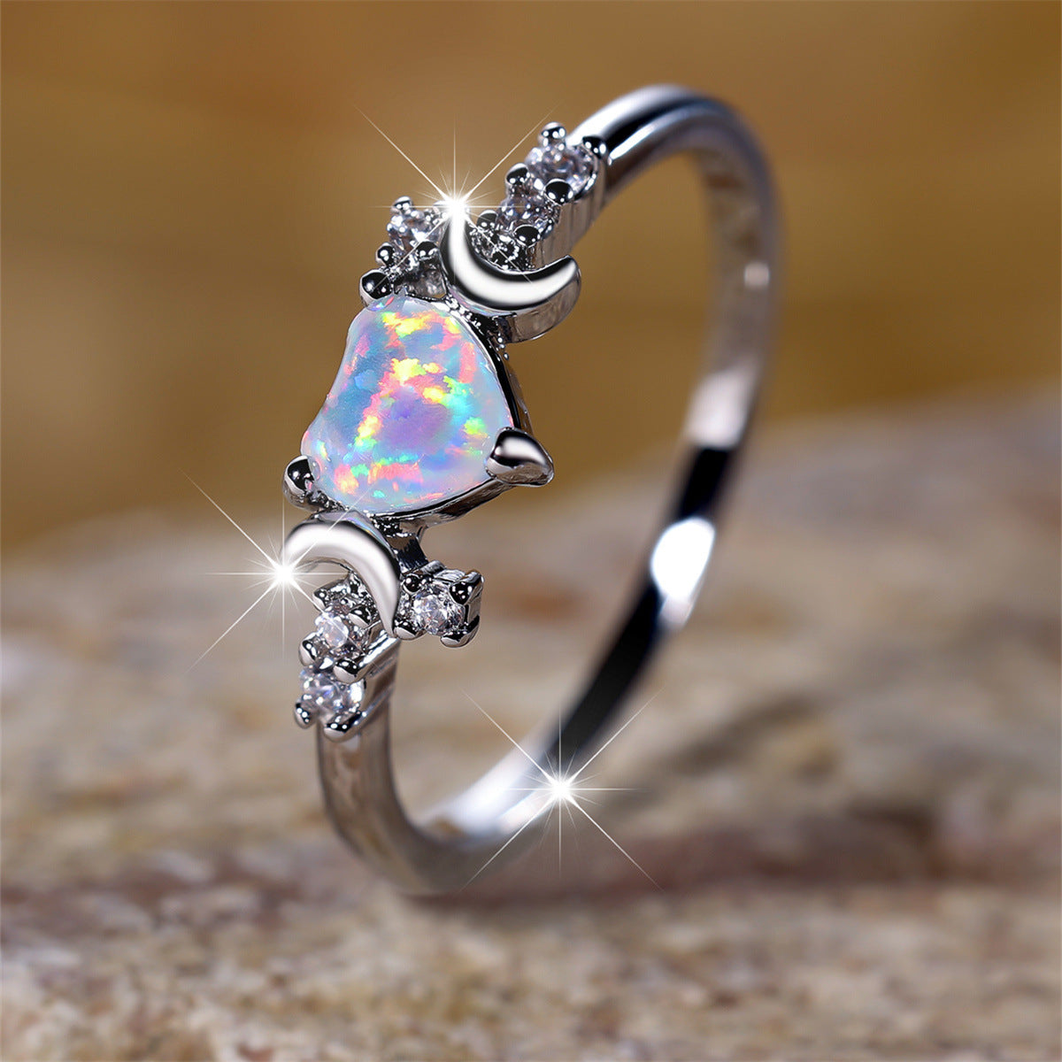 Moonstone love ring with heart-shaped opal stone and crescent moon accents in silver setting