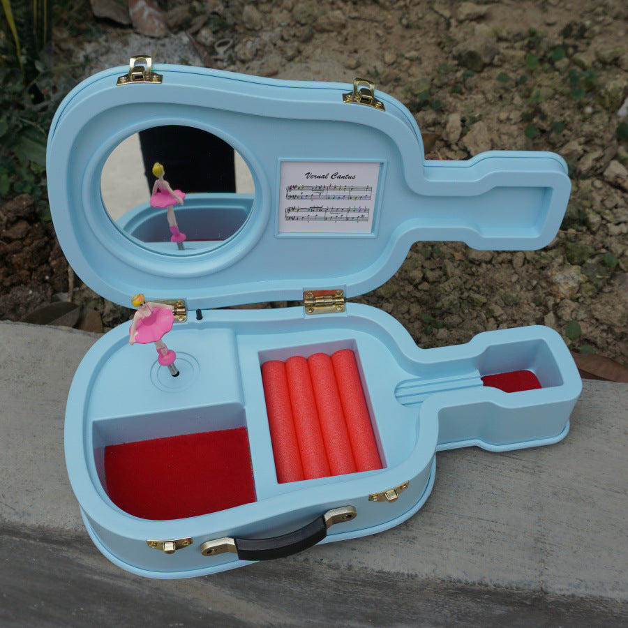 Open blue musical ballet dancer box shaped like a guitar with a pink dancing ballerina figure inside