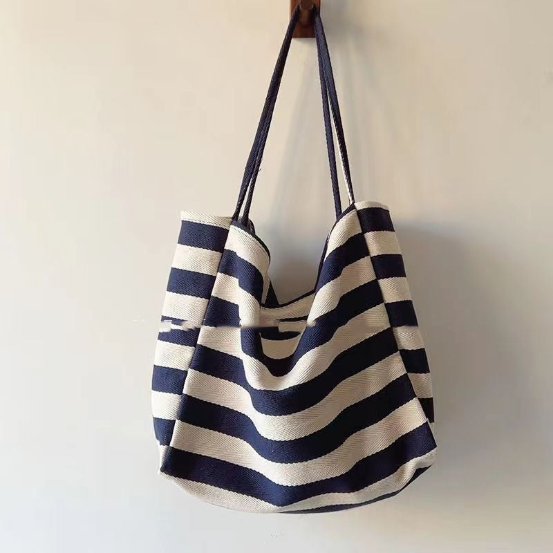 Striped canvas shoulder bag by Sheila Merchandise with bold navy and white artistic contrast color stripes